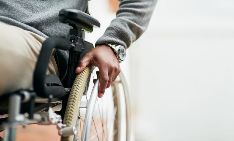 Cropped Shot Of An Unrecognizable Senior Man Sitting In His Wheelchair At Home